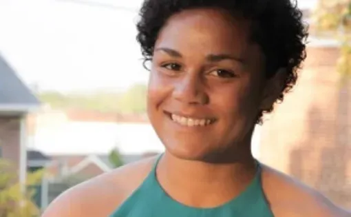 Headshot of Halle wearing a green shirt outside