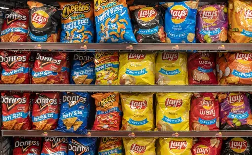 Frito Lay potato and snack chip display. Representing processed foods. Image by Jonathan Weiss/Shutterstock. United States, 2021.