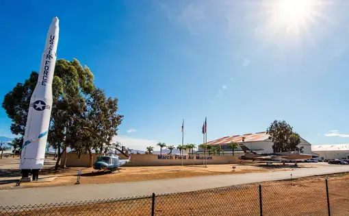 Missiles in front of entrance to March Field Air Museum by March Air Force Base on sunny day. Image by RozenskiP/Shutterstock. United States, 2021.