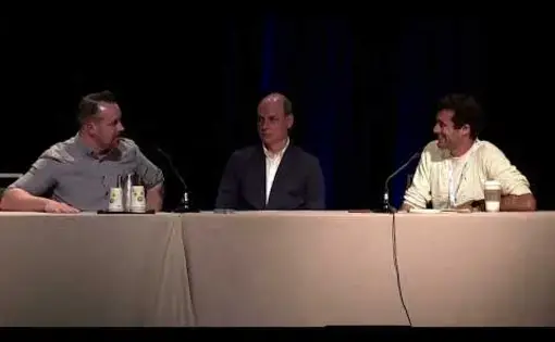 Three people on a stage.