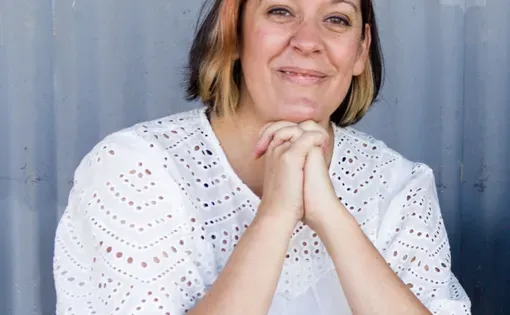 Headshot of Amy wearing a white blouse