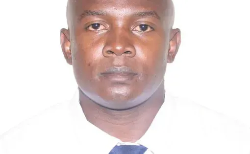 Headshot of Dennis against a white background