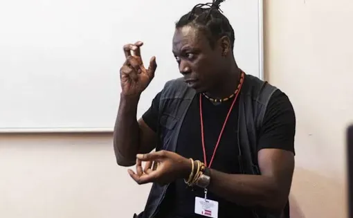 Image of Estacio giving a talk
