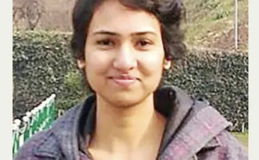 Headshot of Rishika wearing a grey jacket