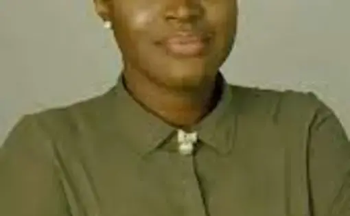 Headshot of Ugochi wearing green