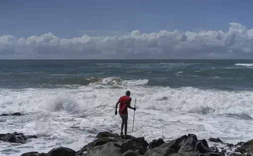 man stands in front of ocean in South Africa