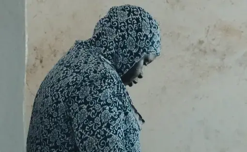 Woman looking downward, Gambia