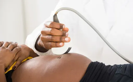 Close-up Of Doctor's Hand Moving Ultrasound Transducer On Pregnant Woman's Belly. Image by Andrey_Popov/Shutterstock.