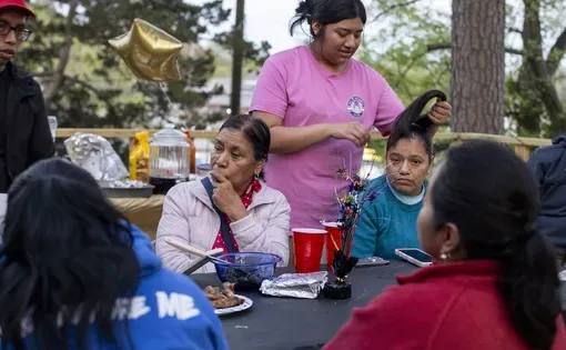 A family celebrating at an outdoor table