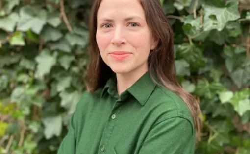 Woman in green shirt with long brown hair