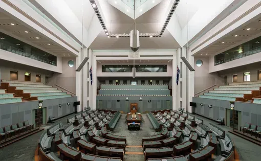 Canberra, Australia - June 11, 2017: The Interiors of the House of Representatives chamber of the Parliament House where federal laws are debated and voted by members. Image by TonyNg/Shutterstock.