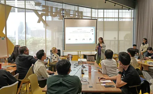 a speaker presents to a room of people
