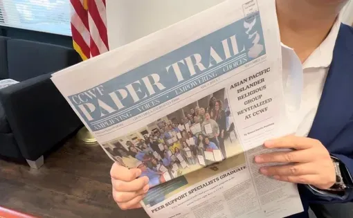 Someone holds a newspaper