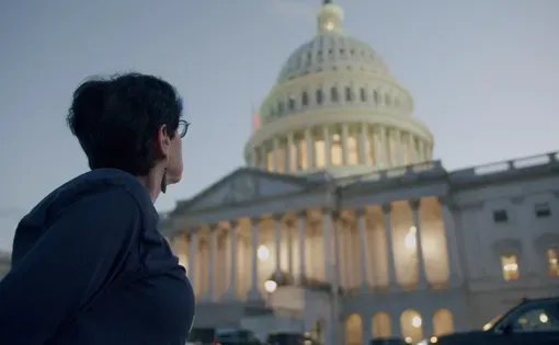 Public defender Heather Shaner looks up at the U.S. Capitol building.