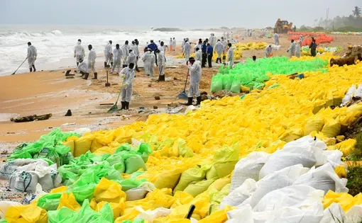 Sri Lankan navy soldiers are seen working in a beach in Pamunugama western province Sri Lanka for the removal of debris washed ashore from the burned container ship MV X-Press Pearl. 5th June 2021. Image by Ruwan Walpola/Shutterstock.