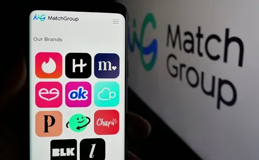 Image of phone with dating apps like Tinder and Hinge next to screen with brand logo for Match Group company