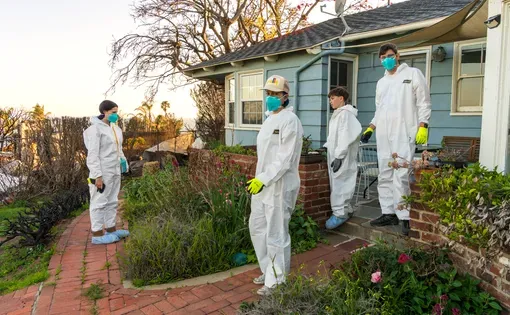 Winter Reign (center) and Brendan Armm (right) regroup with their children, River and Leaf, as they clean their Pacific Palisades home on April 6 after it sustained smoke and soot damage from the Los Angeles wildfires.