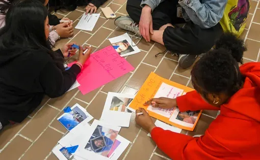 Students collaborate on making posters with photographs