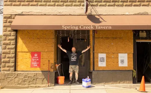 Tim Arnett in front of his business