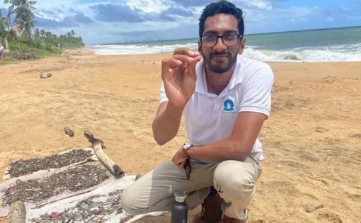 Muditha Katuwawala shows tiny nurdles collected from a beach in Sri Lanka.