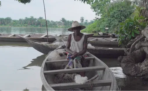 Fisherman Nombare Tabu sits in his canoe at Nweemy creek.