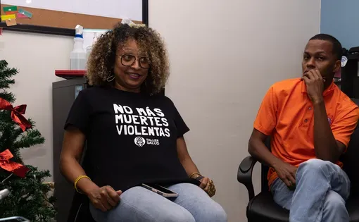 People wearing t-shirts and jeans sit in an office