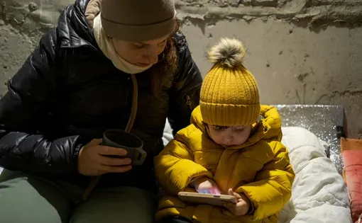 The war between Russia and Ukraine. Children sit in the bomb shelter. Air alarm.