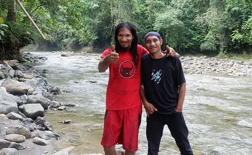 Two men pose for photo