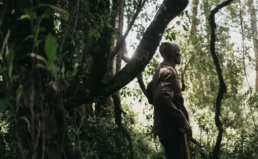 Benson Ngusilo stands in the Sasimwani area of the Mau Forest Complex, from which he and the rest of his Indigenous Ogiek community was evicted in late 2023.