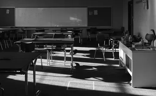 dark classroom with desks
