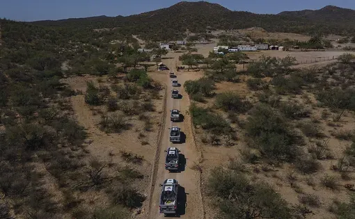 A convoy of state police vehicles arrives at the La Ciénega gold mine in the Mexican state of Sonora on June 23.(Félix Márquez / For The Times)