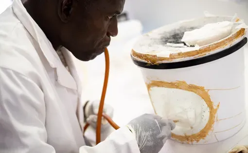 Fanuel Toto, insectary assistant, works on transferring female mosquitos to a container using a suction tube in the Zimbabwe Entomological Support in Malaria Control Programme’s insectary at Africa University in Mutare, Zimbabwe.