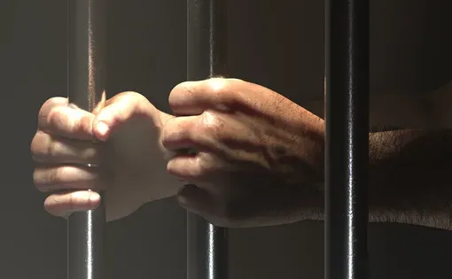 Hands on jail bars