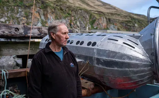 Omar Sørvik stands next to his invention, the Sago Solutions capsule, aboard the fishing boat Oracle on May 29 in Dutch Harbor.