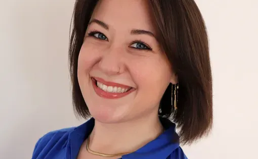 Headshot of brunette woman in blue button down