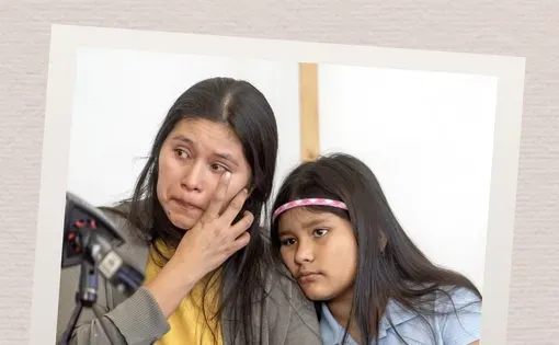 A tearful woman sits with a girl
