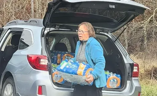 Betty Stepp helps out with water distribution