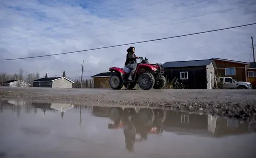 A person rides an ATV in Webequie, Ont., on Thursday, Oct. 23, 2025. THE CANADIAN PRESS/Christopher Katsarov