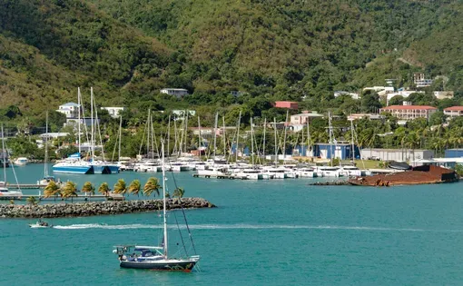 A sailboat crosses the harbor in the British Virgin Islands