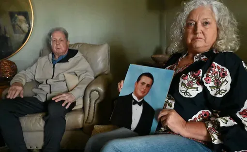 William Aycock III and Laurenda Provias with a photograph of their son William Aycock IV, who was fatally injured in a Rankin County jail cell in 2018.