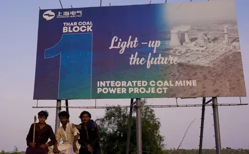 People in front of sign
