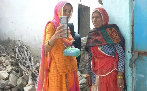 Dali Devi tries to carry out facial authentication in a Bhil hamlet. Photo: Priyanka Verma