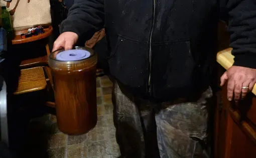 Chris Coleman, of Gary, McDowell County, holds a water filter he had just removed from his family’s water system in this November 2018 file photo. Coleman said at the time that reddish-brown, muddy water is what flowed into their pipes before it hit the filter.