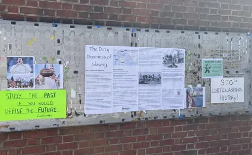 “Stop whitewashing history!” board