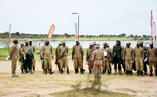 Soldiers standing in front os a lake