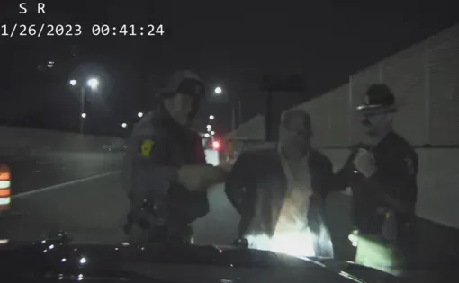 Dash-camera footage of Illinois State Police Trooper Kevin Bradley (left) arresting Raymond Theus on suspicion of DUI in 2023. Theus’ charges were dropped in April 2026 after inconsistencies between what Bradley alleged in his arrest report and what was captured on camera. Credit: Illinois State Police