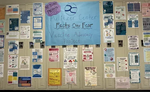 A collection of student-created vaccine awareness flyers hangs in a hallway at Troy High School. Image by Rebecca Brewer.
