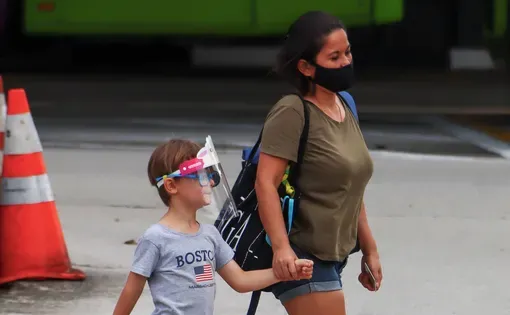Migrant worker walking with a boy