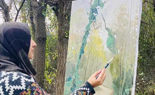 A woman paints a picture
