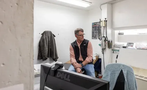 Physician assistant Greg Ellis sits in the Franklin County Detention Center’s closet-like medical space in Farmington in March.